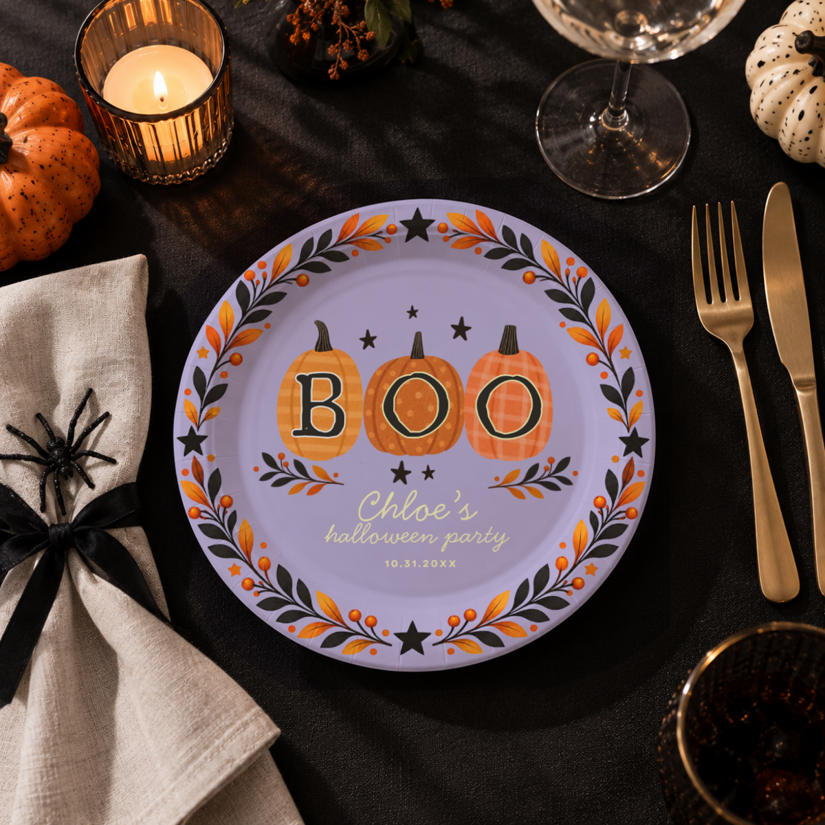 Close-up of the three patterned pumpkins spelling BOO inside an autumn wreath on personalized pumpkin paper plates