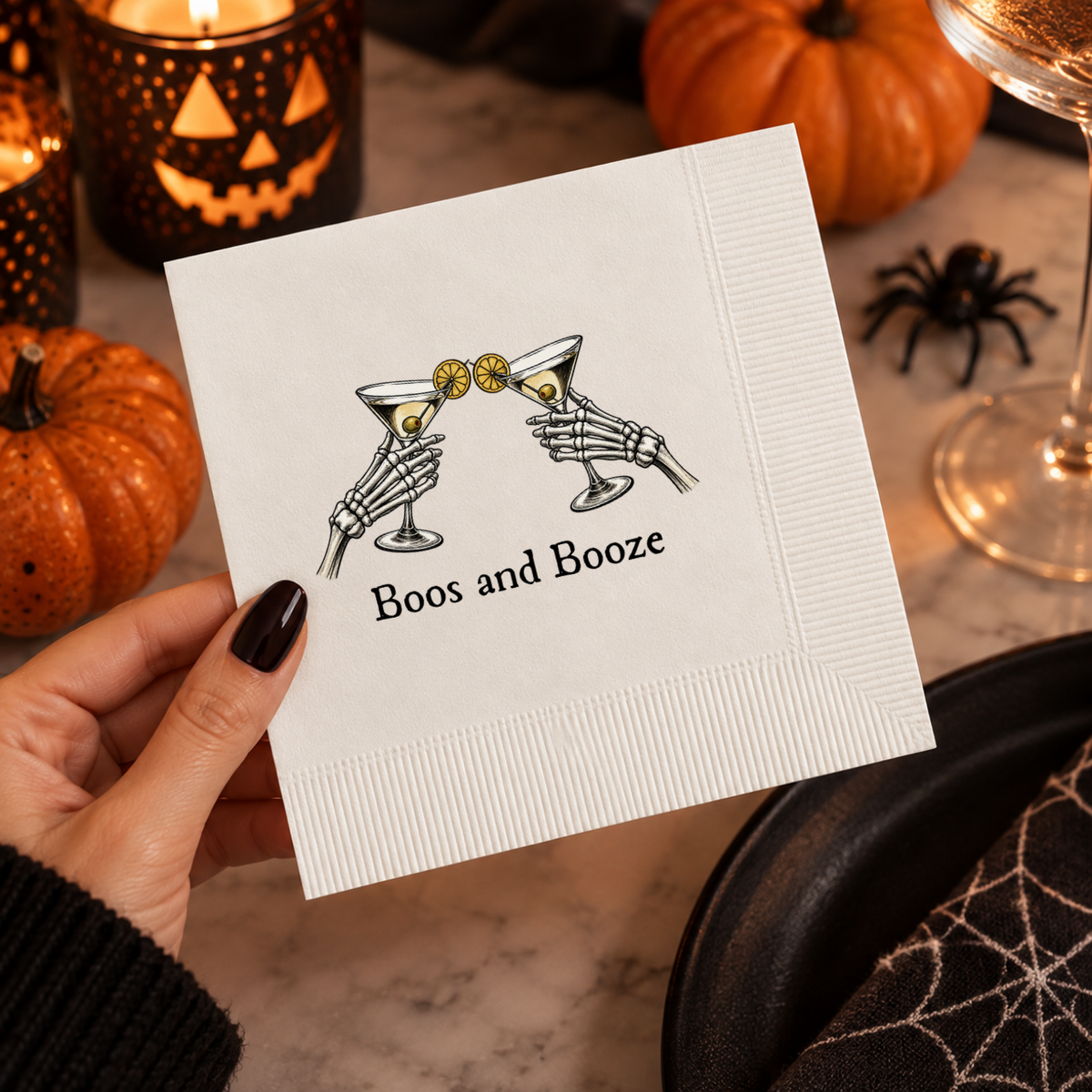Halloween cocktail napkins personalized with your name and date, two skeleton hands clinking martinis above Boos and Booze