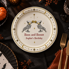 Skeleton cocktail halloween paper plates personalized with your name, the two skeleton hands clinking martinis above Boos and Booze