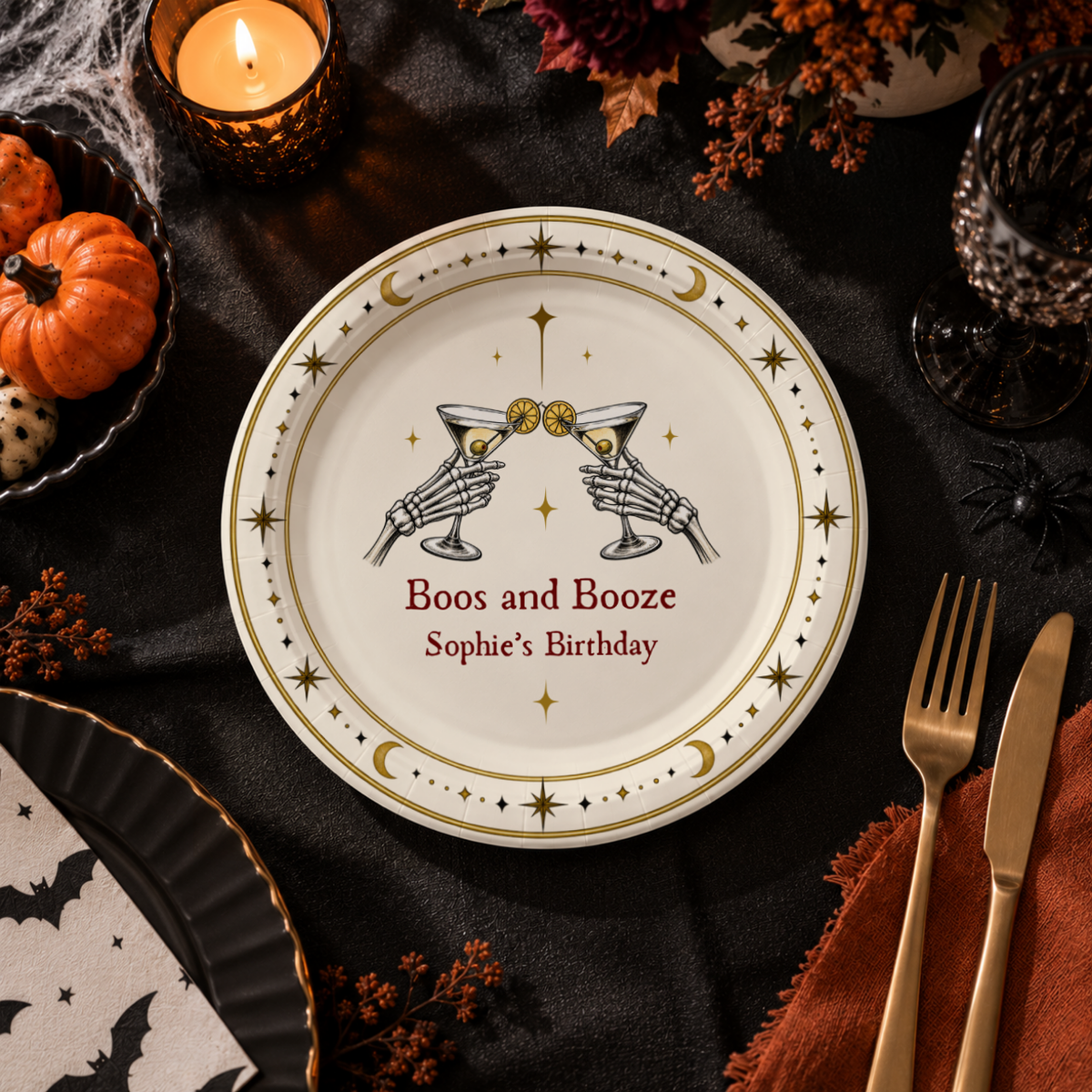 Close-up of the two skeleton hands clinking martinis above Boos and Booze on personalized skeleton cocktail halloween paper plates