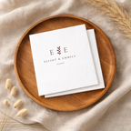 Monogrammed wedding napkins with a botanical wreath around the initials