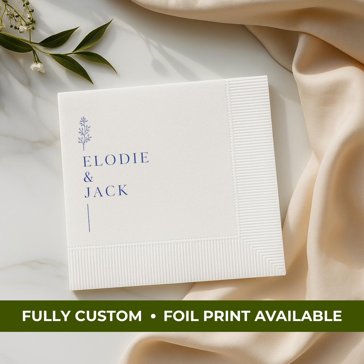 Wedding napkin with botanical greenery around the couple's names