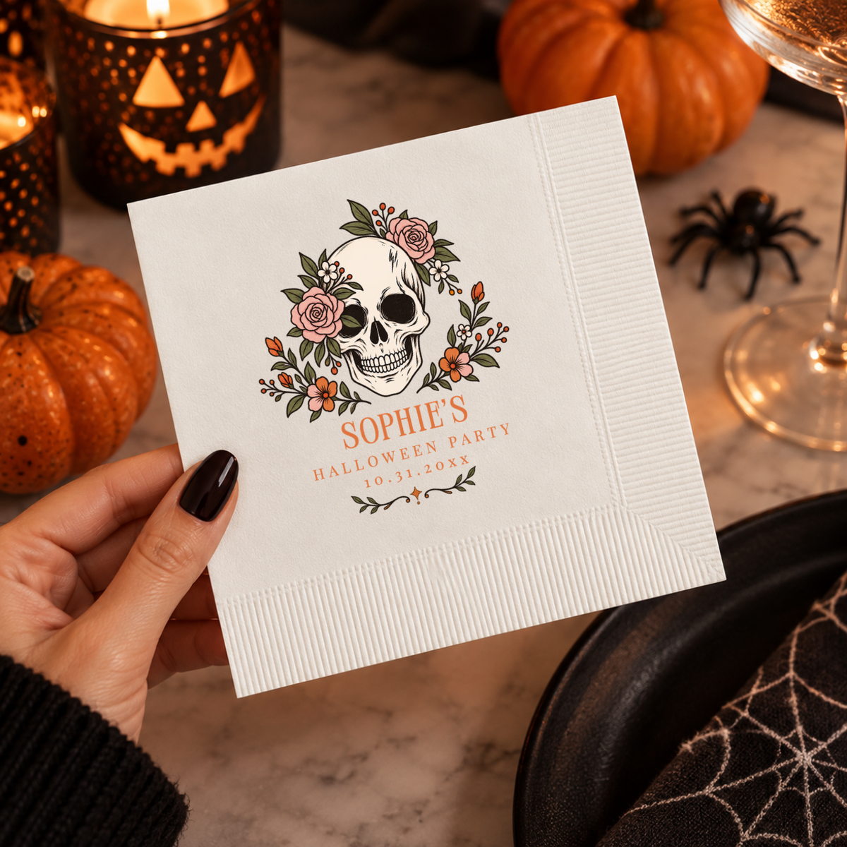 Close-up of the skull wreathed in roses and orange blooms on personalized Halloween napkins
