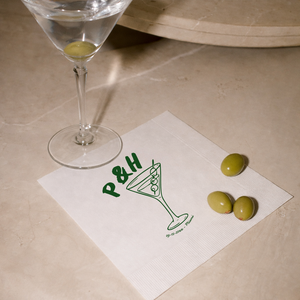 Monogrammed wedding napkins with a martini glass above the initials