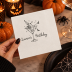 Close-up of the party skeleton lounging in a martini glass on personalized Halloween birthday napkins