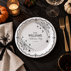 Close-up of the white spiderwebs and hanging spiders on a black plate on personalized spiderweb halloween paper plates