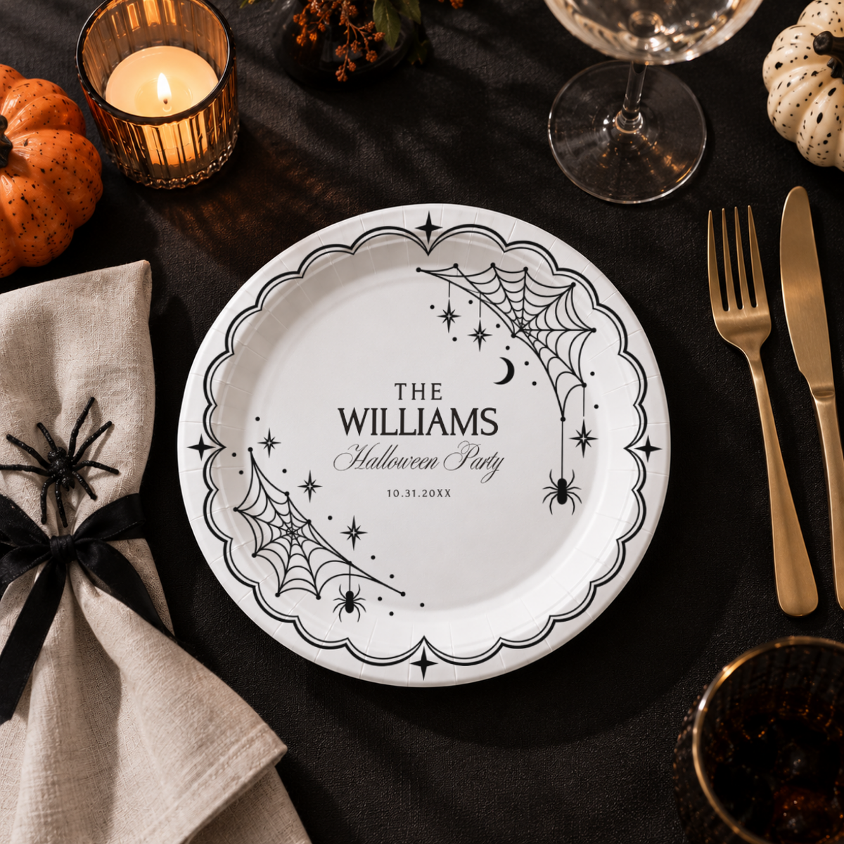 Close-up of the white spiderwebs and hanging spiders on a black plate on personalized spiderweb halloween paper plates