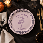Witch birthday paper plates personalized with your name, the witch on a martini glass inside a pink ribbon and bow border