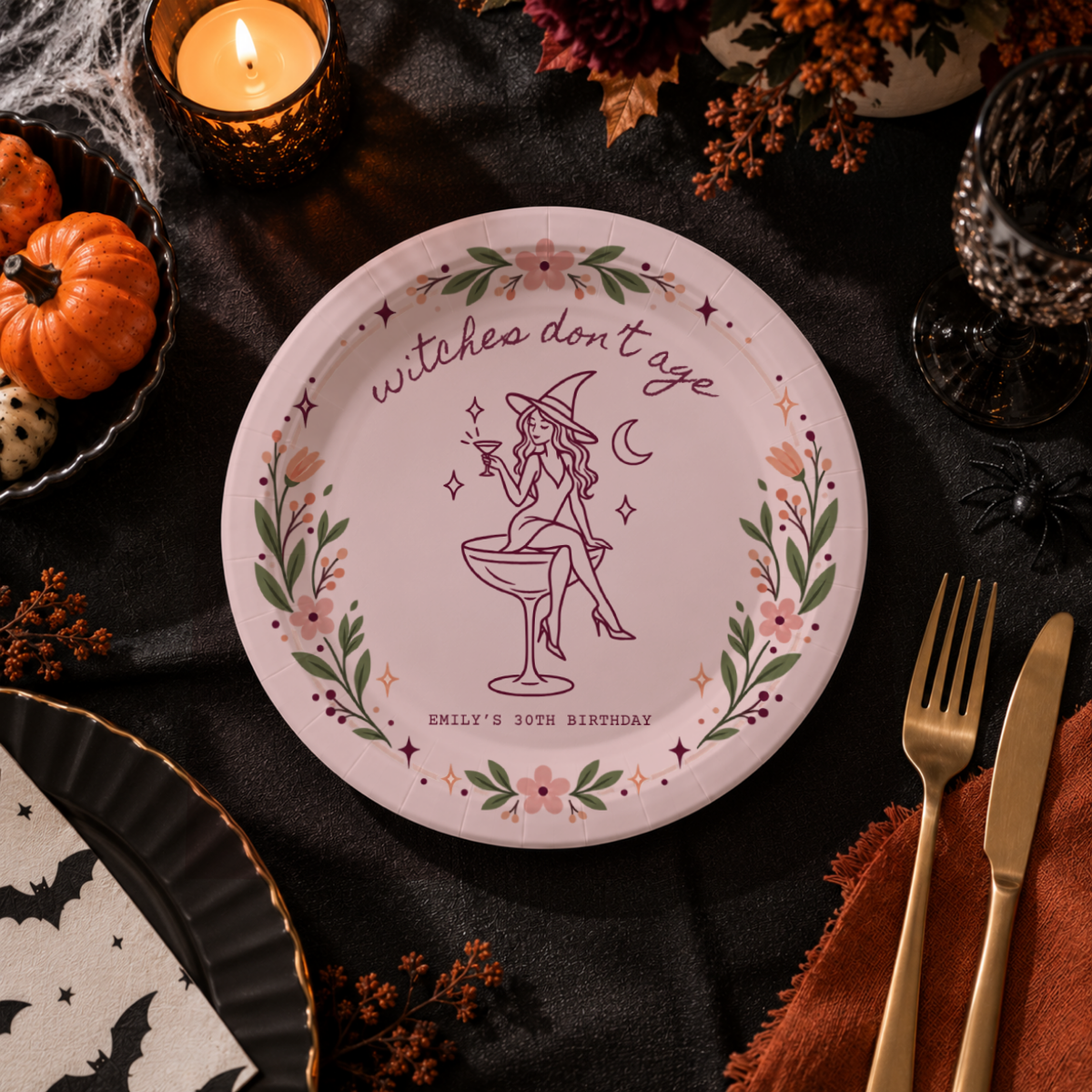 Witch birthday paper plates personalized with your name, the witch sitting on a coupe glass under Witches Dont Age
