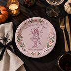 Close-up of the witch sitting on a coupe glass under Witches Dont Age on personalized witch birthday paper plates